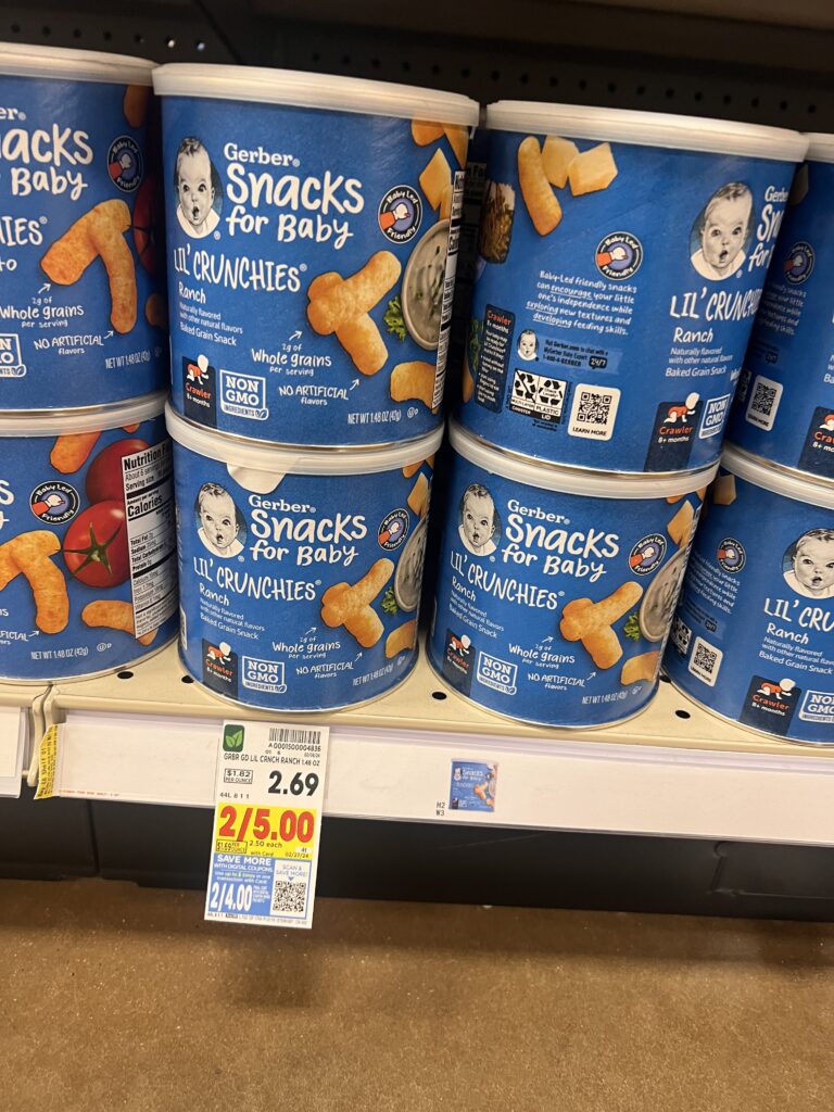 Four buckets of snacks for baby are on display in a store.